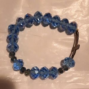 Blue crystal stretch bracelet with copper colored cross
